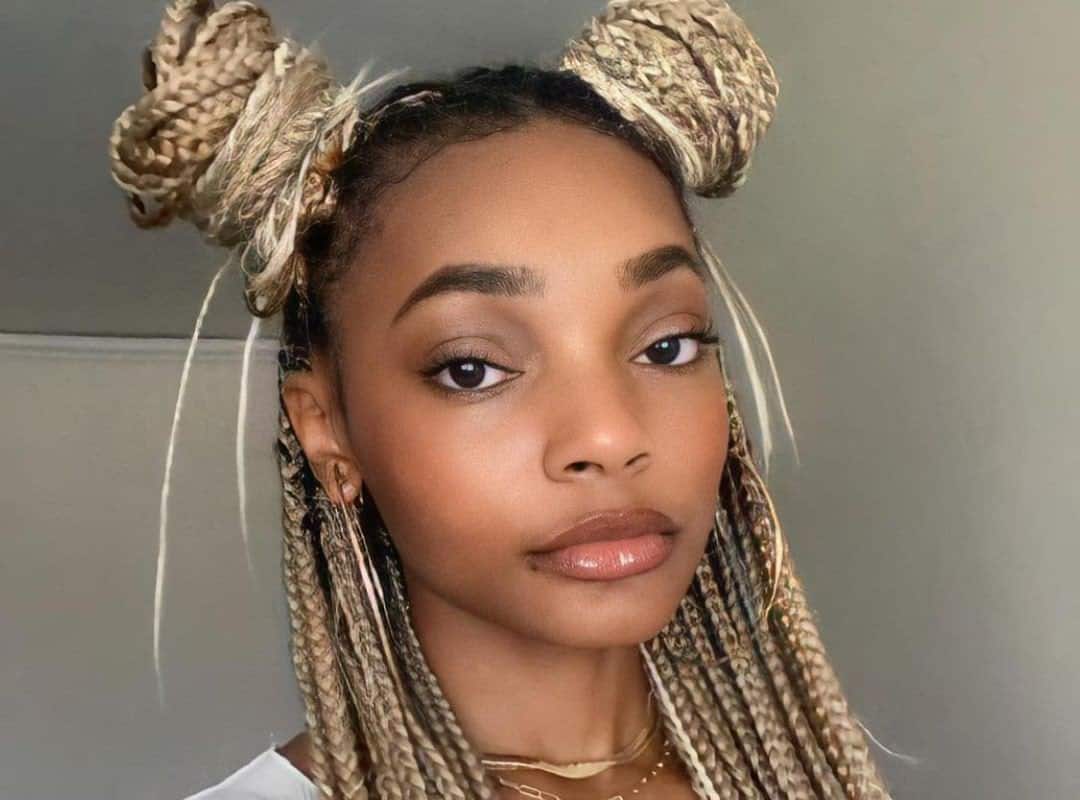 girl with black and blonde top bun for tribal braids with beads