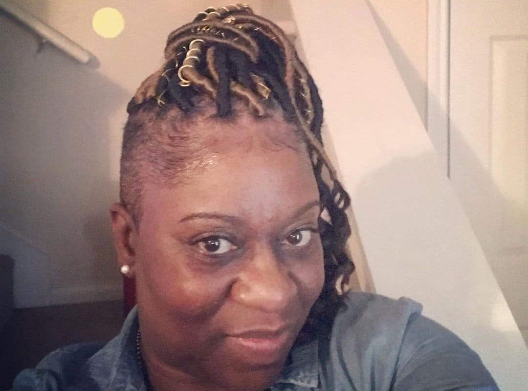 woman with black and brown top bun for tribal braids with ribbons
