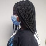 girl with black box tribal braids with white beads