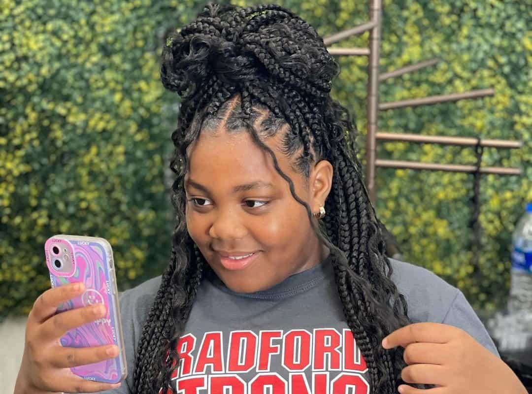 girl with black tribal braids in bun with beads and curls 