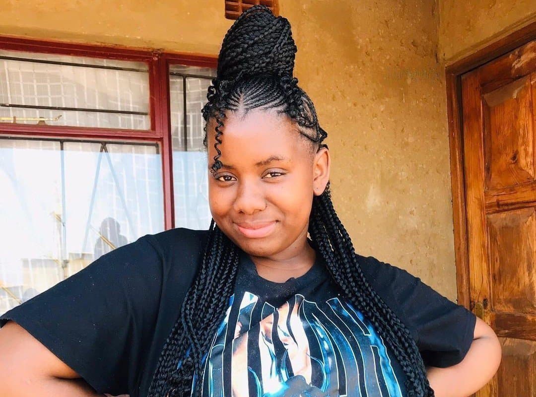 woman with black tribal braids with beads and curls