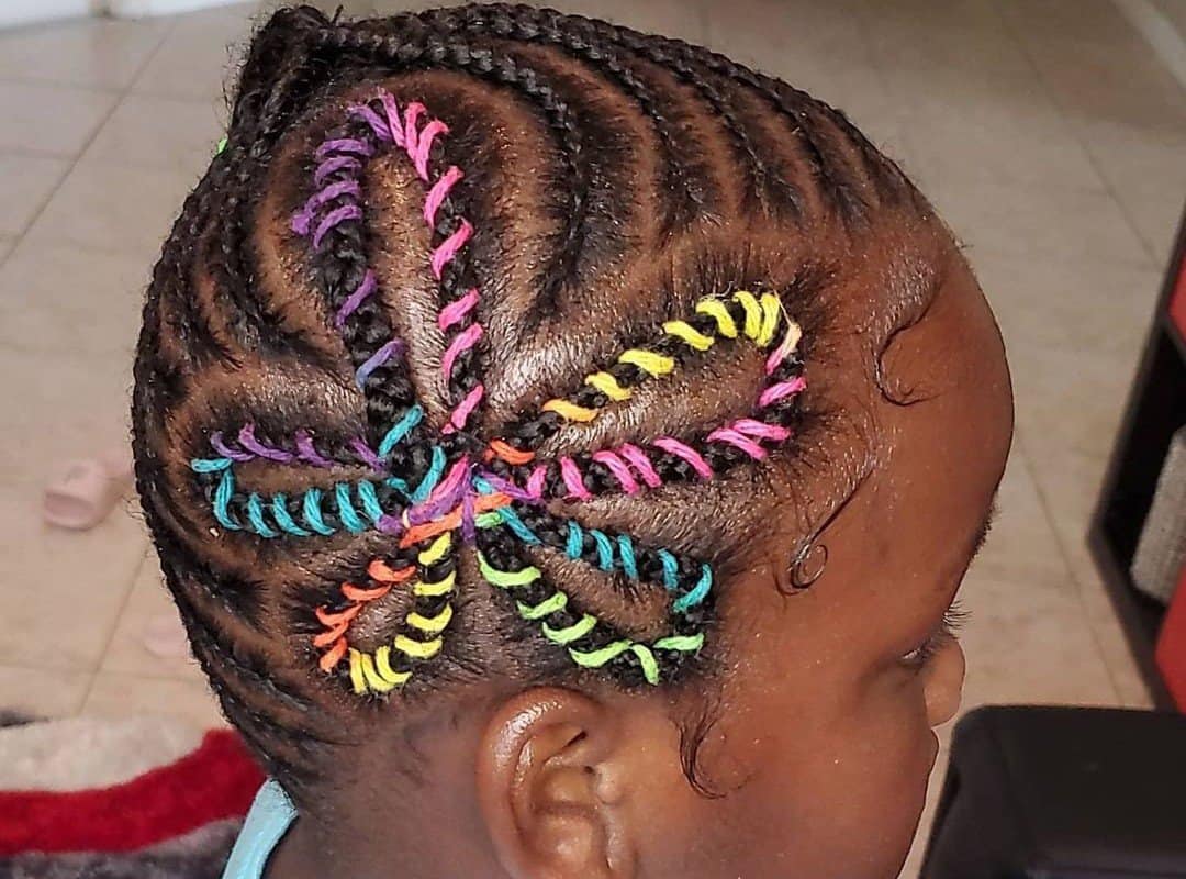 girl with black tribal braids with flower