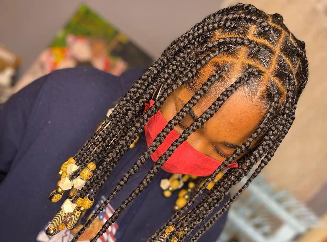 woman with black tribal braids with natural beads