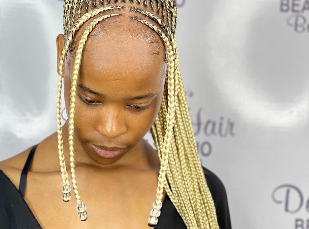 girl with blonde and brown box tribal braids with beads