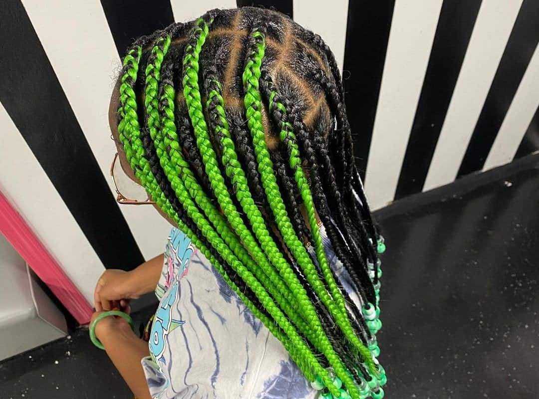 girl with brown and green tribal braids with green beads