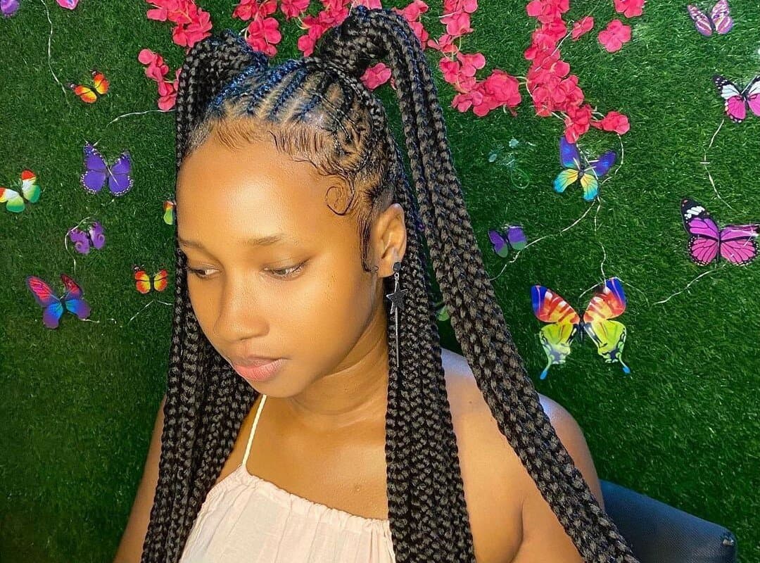 girl with brown fulani tribal braids with beads in ponytails