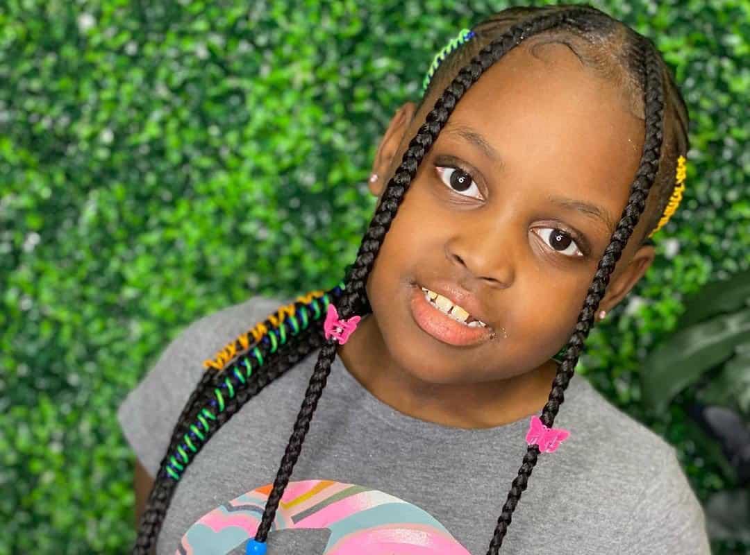 girl with brown tribal braids with colored beads and ribbons
