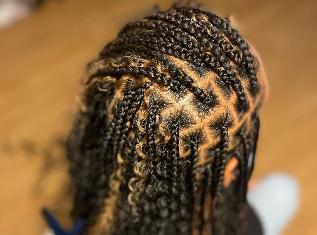 girl with dark brown and blonde tribal braids with beads and curls