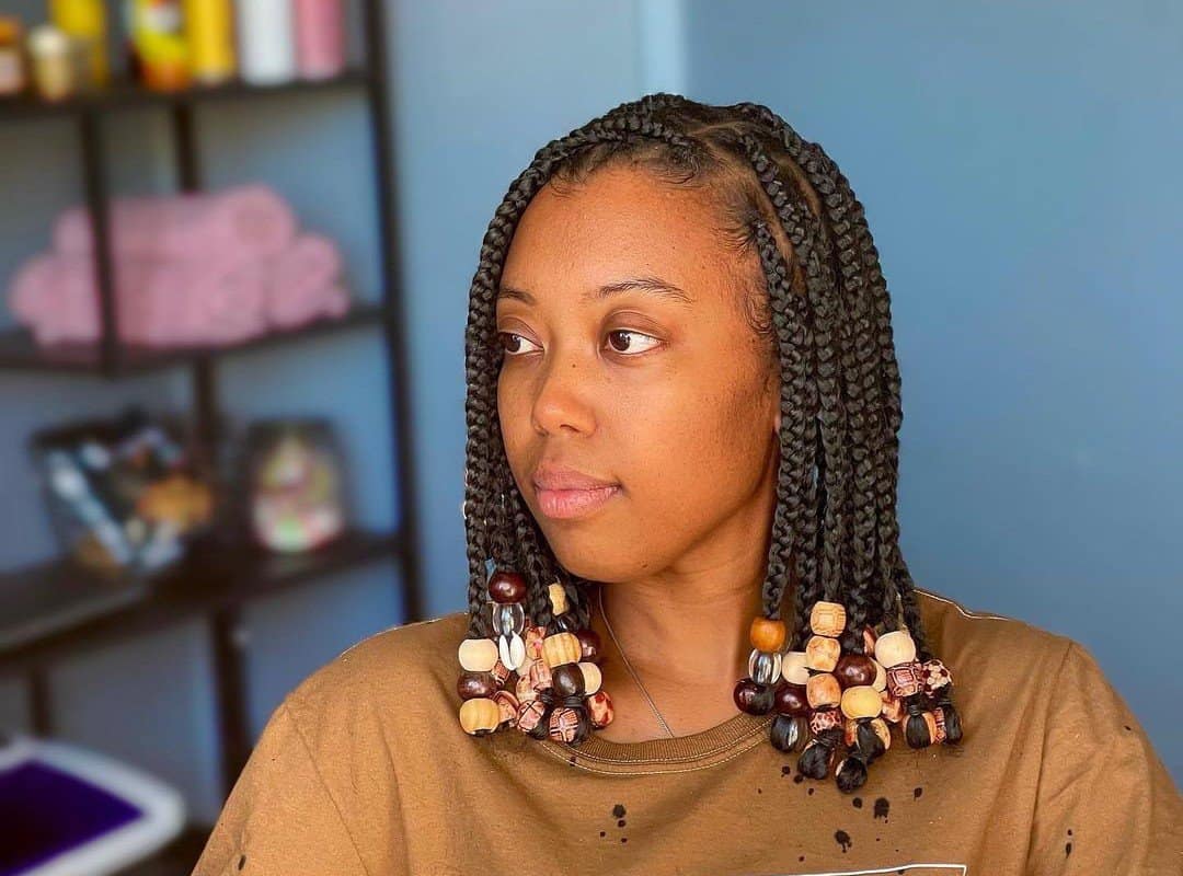 woman with dark brown bob tribal braids with natural brown beads