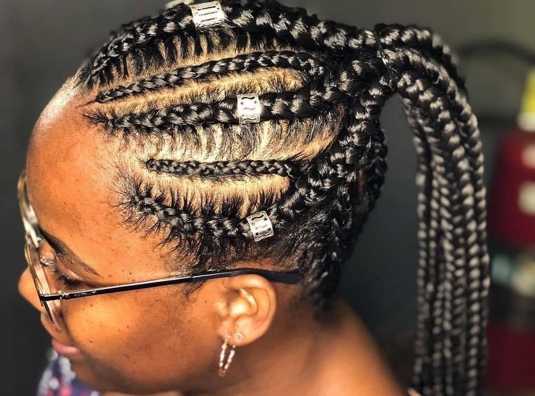 woman with dark brown tribal braids with beads in ponytail