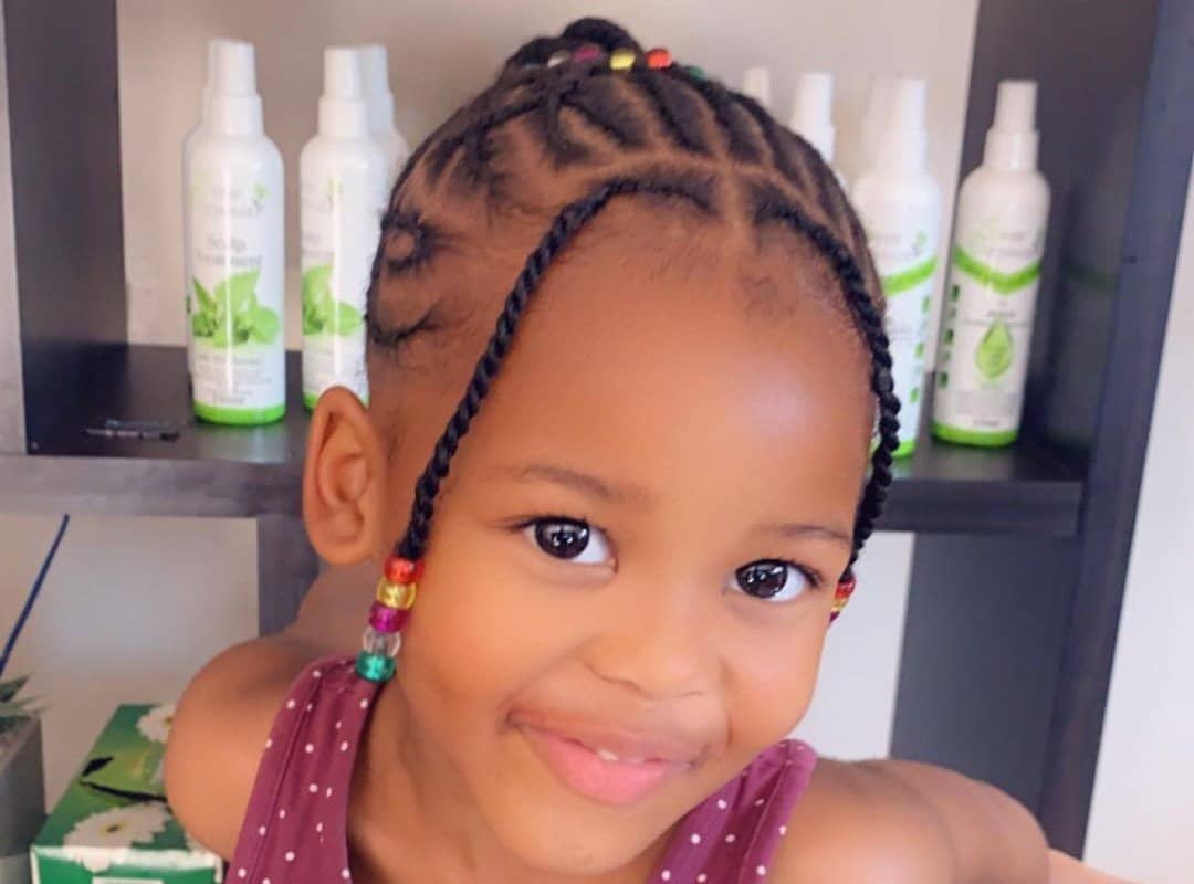 girl with dark brown tribal braids with colored and transparent beads