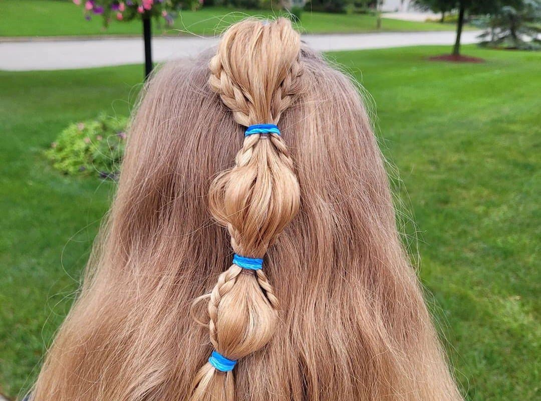 girl hair with half up, half down and elastic bands