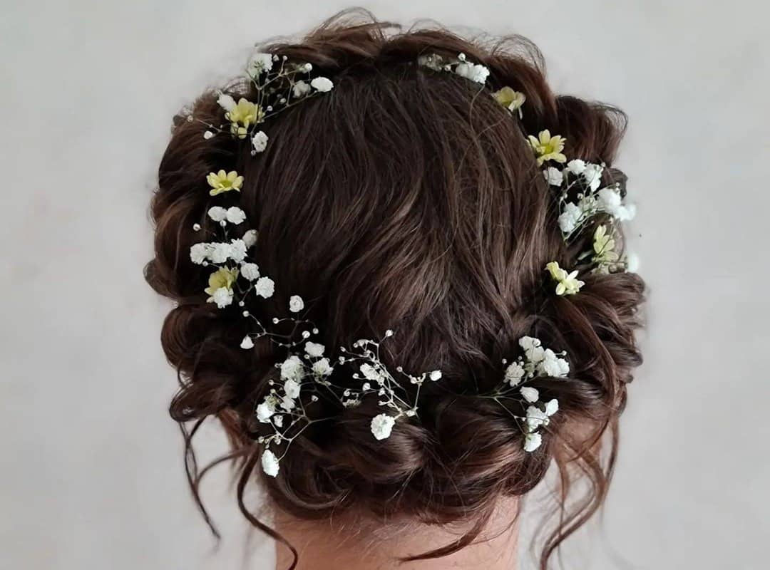 a girl with a braided crown and flowers