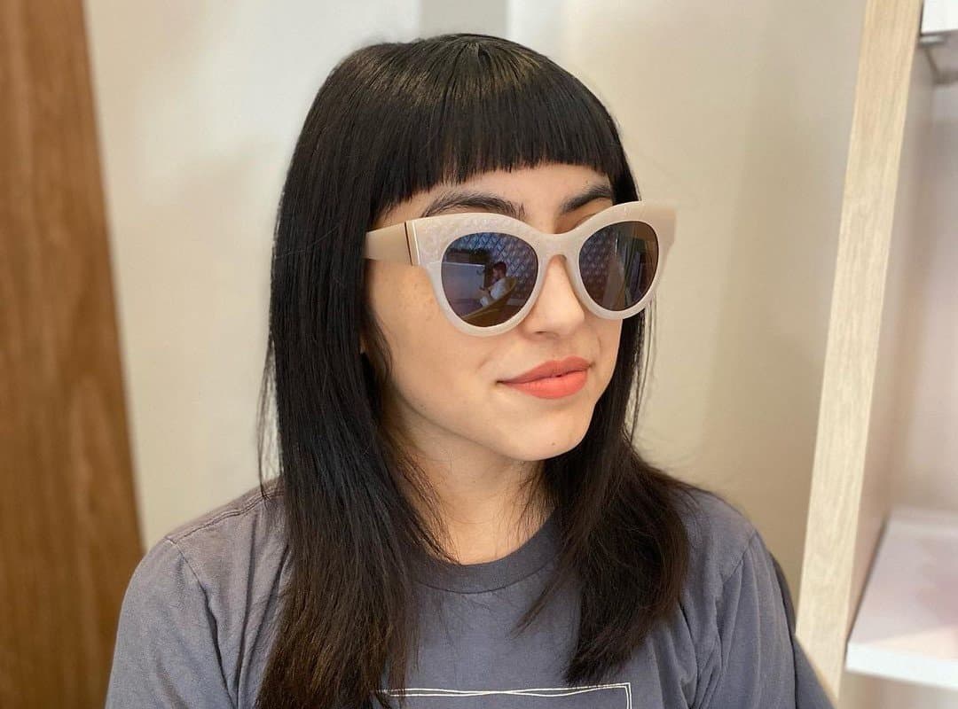 girl with baby bangs in sunglasses