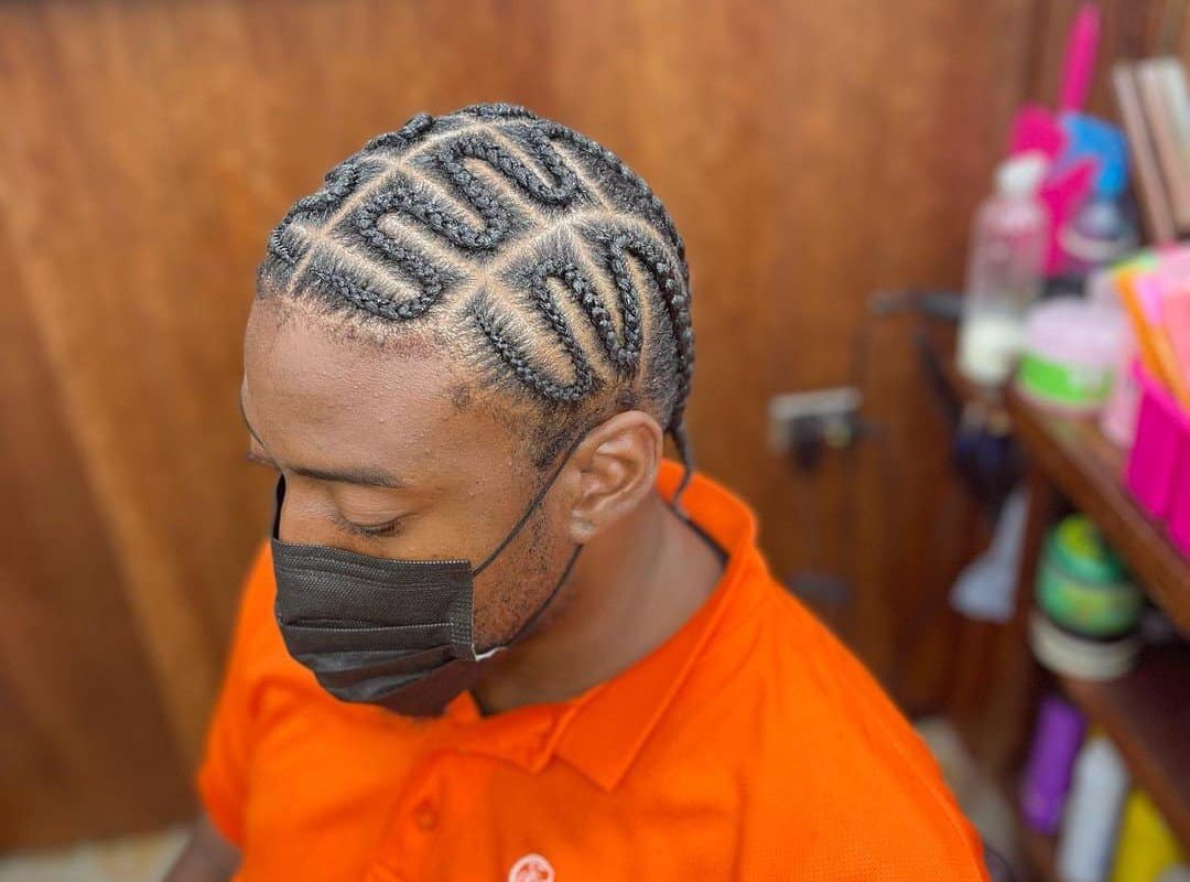 man with brown zig-zag braids in symmetrical design