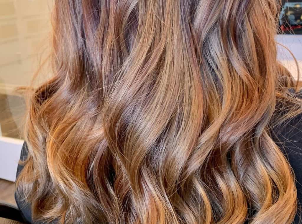 Long brown waves with butterscotch caramel balayage