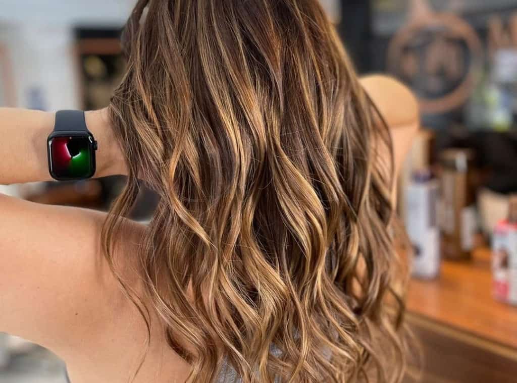 Curly hair with Butterscotch caramel balayage