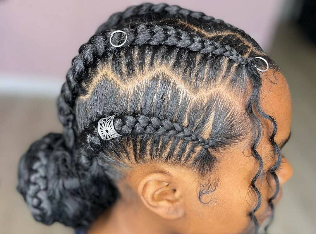 girl with black 4 knotless braids in bun with decorations