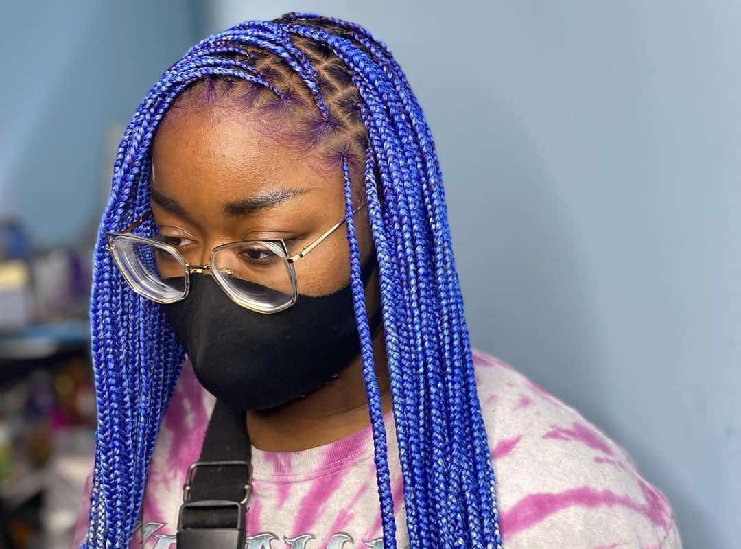 girl with black and blue-white ombre knotless braids and glasses