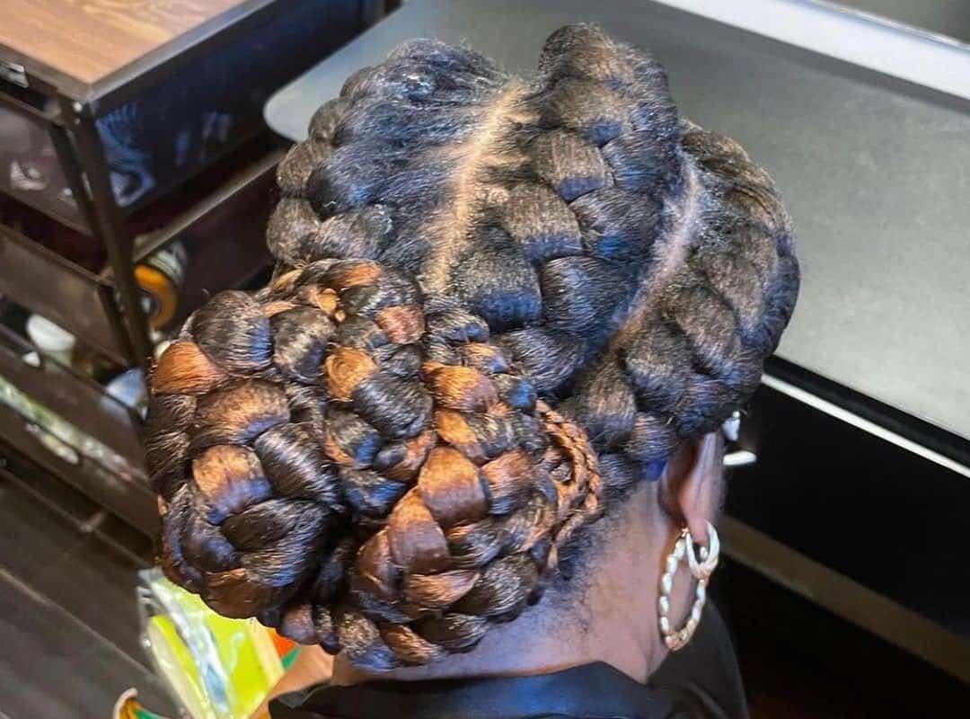 girl with black and brown 4-fishtail braids in bun