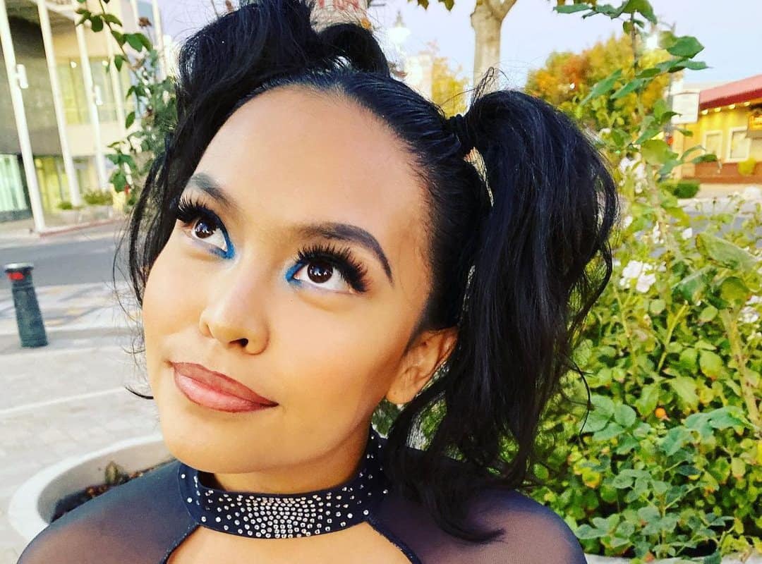 girl with a black cheer high ponytails