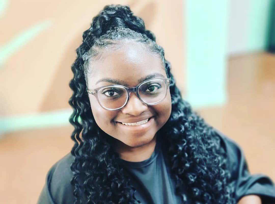 girl with black сrochet ponytail and glasses
