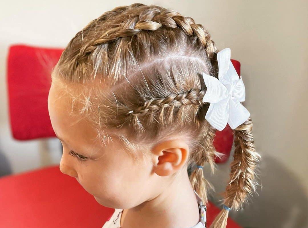 girl with blonde 4-dutch braids with a flower bow