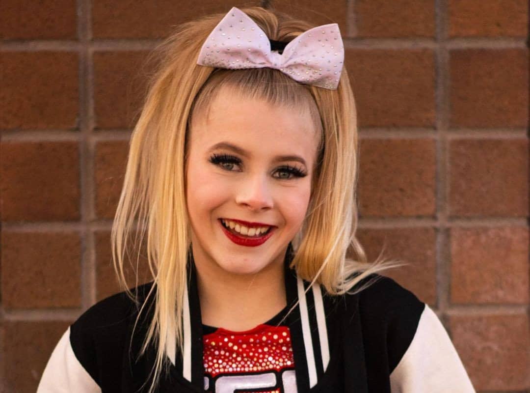 girl with cheer blonde ponytail and cheer bow