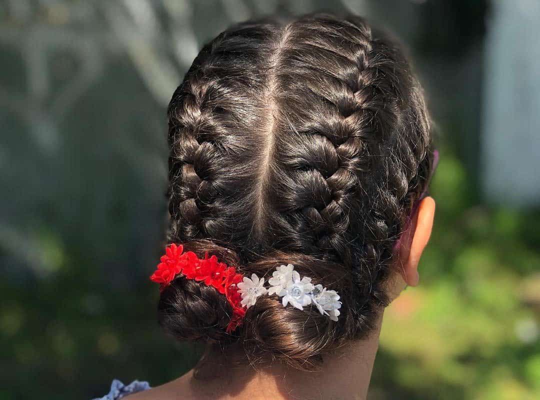 girl with brown 4-french braids in buns and flowers