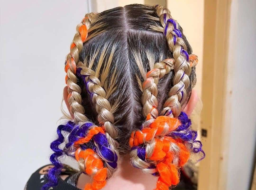 girl with brown and blonde 4-dutch braids with red and blue ribbons