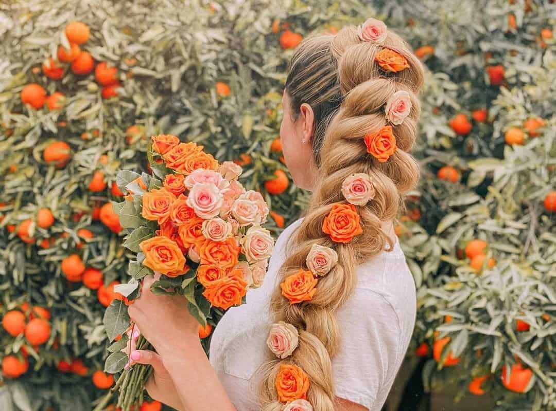 girl with brown and blonde braid with flowers