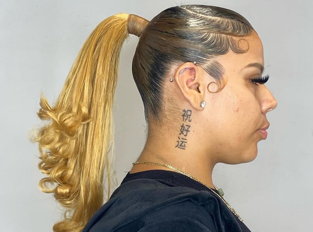 girl with brown and blonde swoop ponytail with weave