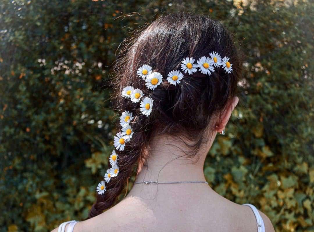 girl with brown braid with flowers