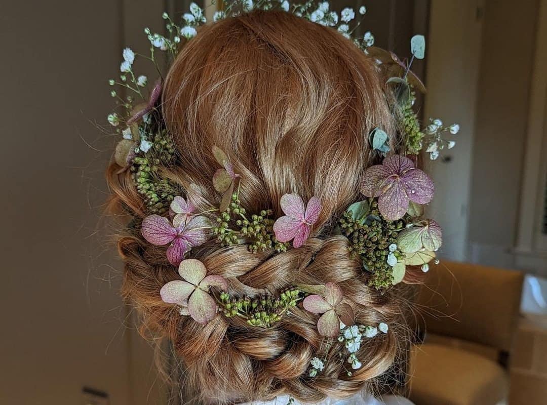 girl with brown braided crown with flowers
