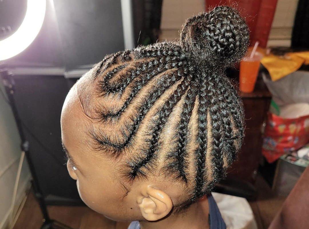 girl with a dark brown braided cheer bun