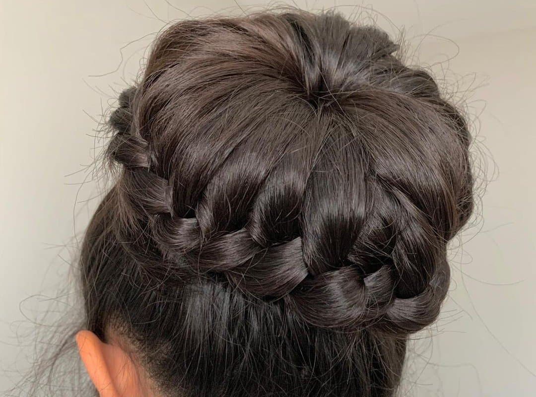 girl with a brown braided cheer bun