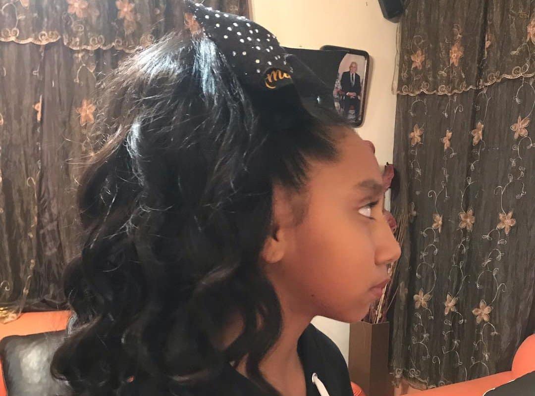 girl with brown cheer half up, half down hairstyle