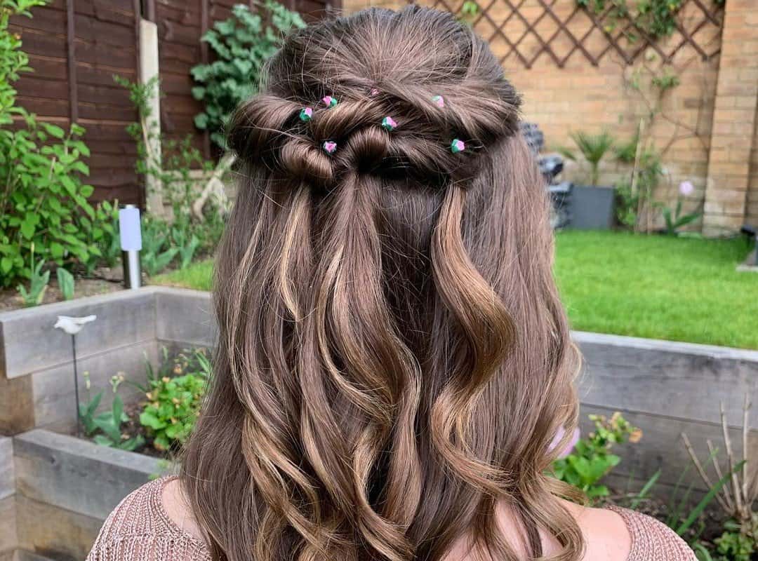 girl with brown half updo with flowers