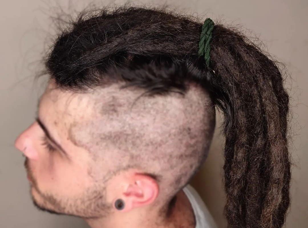 man with brown hippie dyed dreads in ponytail