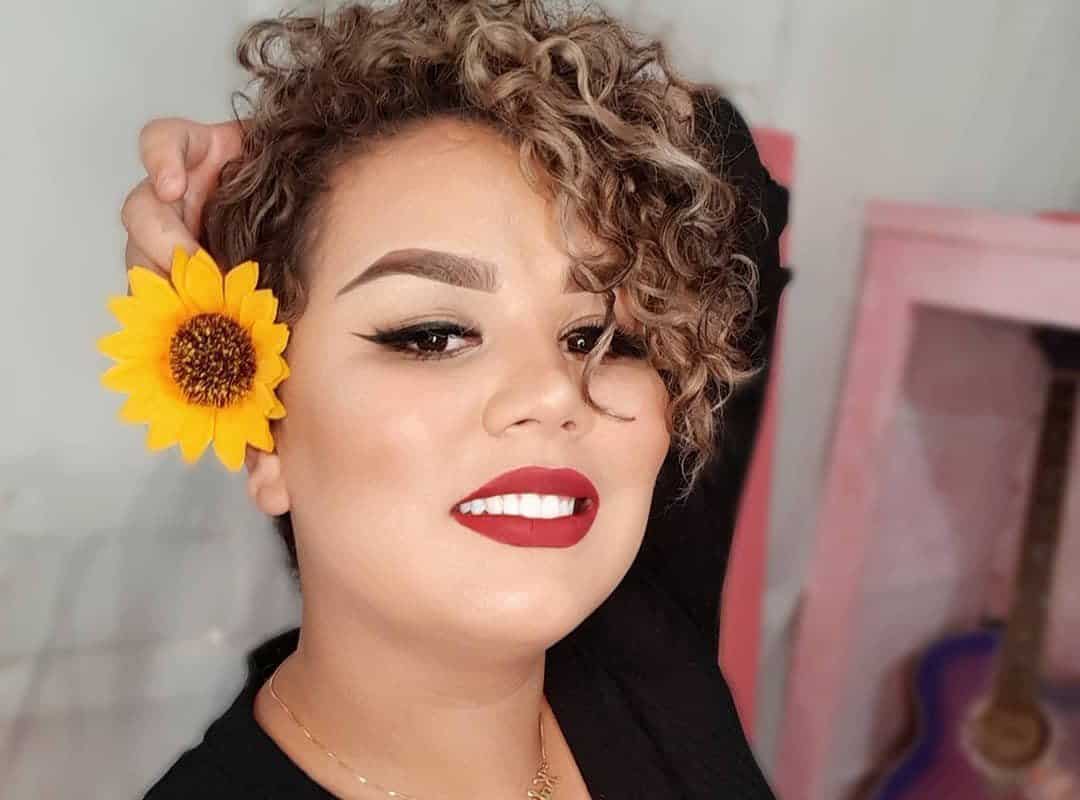girl with brown pixie cut with flower