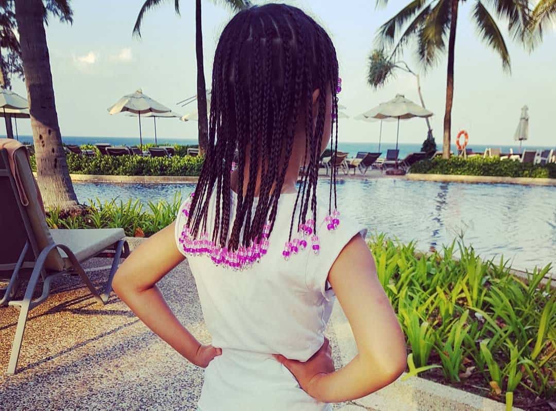 girl with brown thai braids and beads