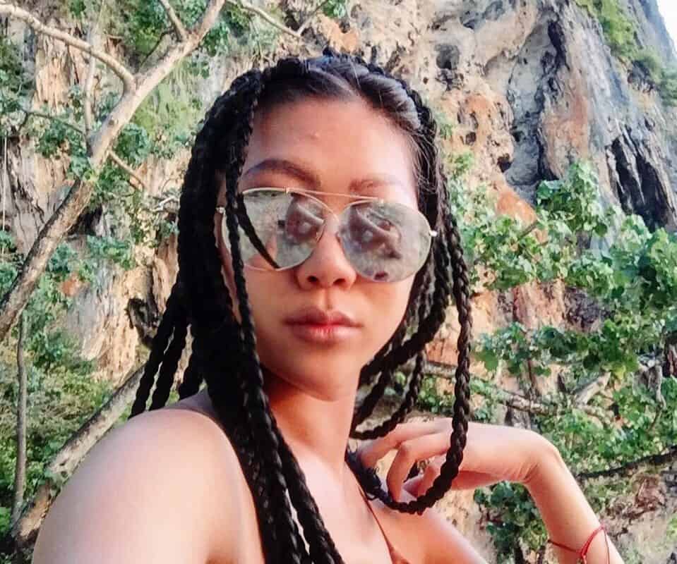 girl with brown thai braids and sunglasses