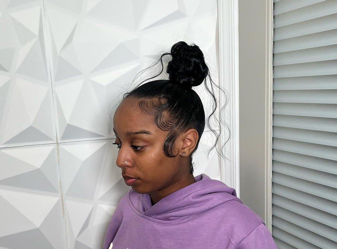 the girl with the brown top knot