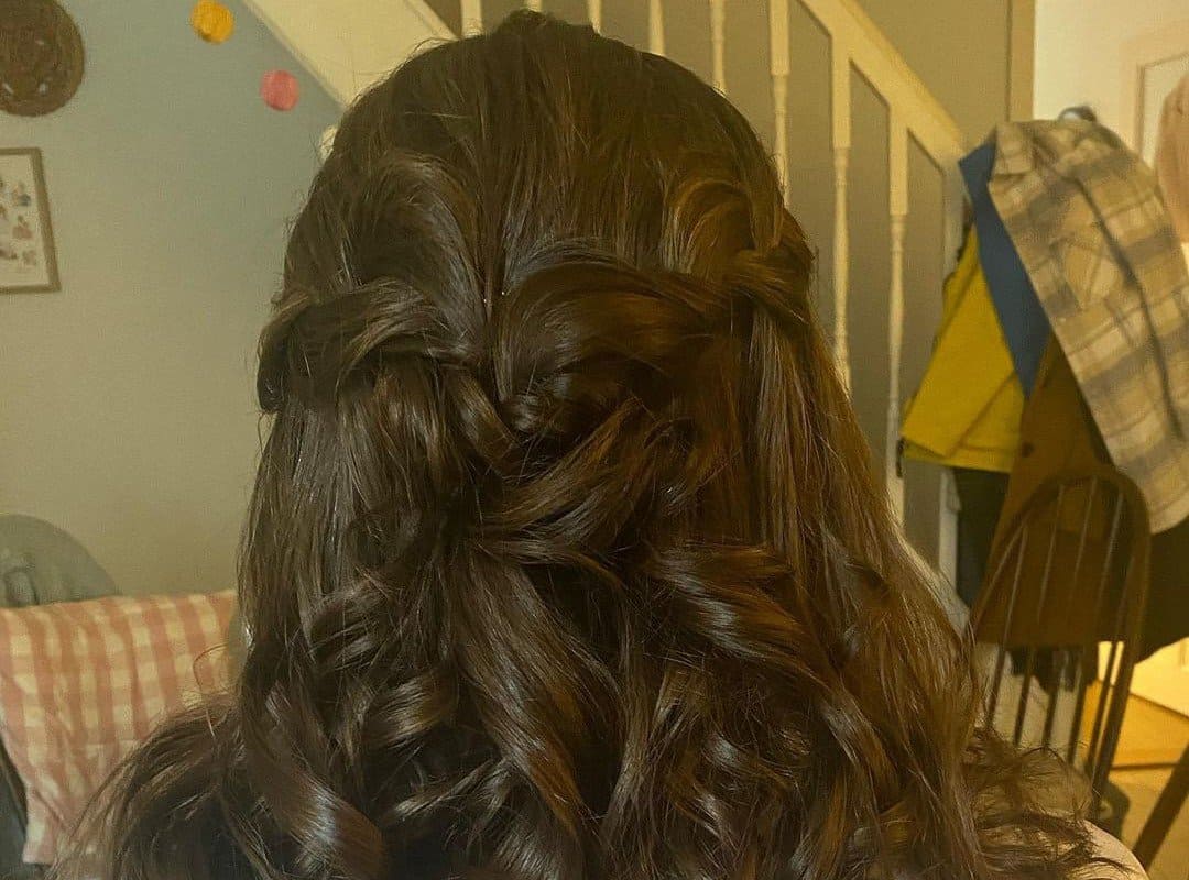 girl with dark brown cheer half up half down hairstyle