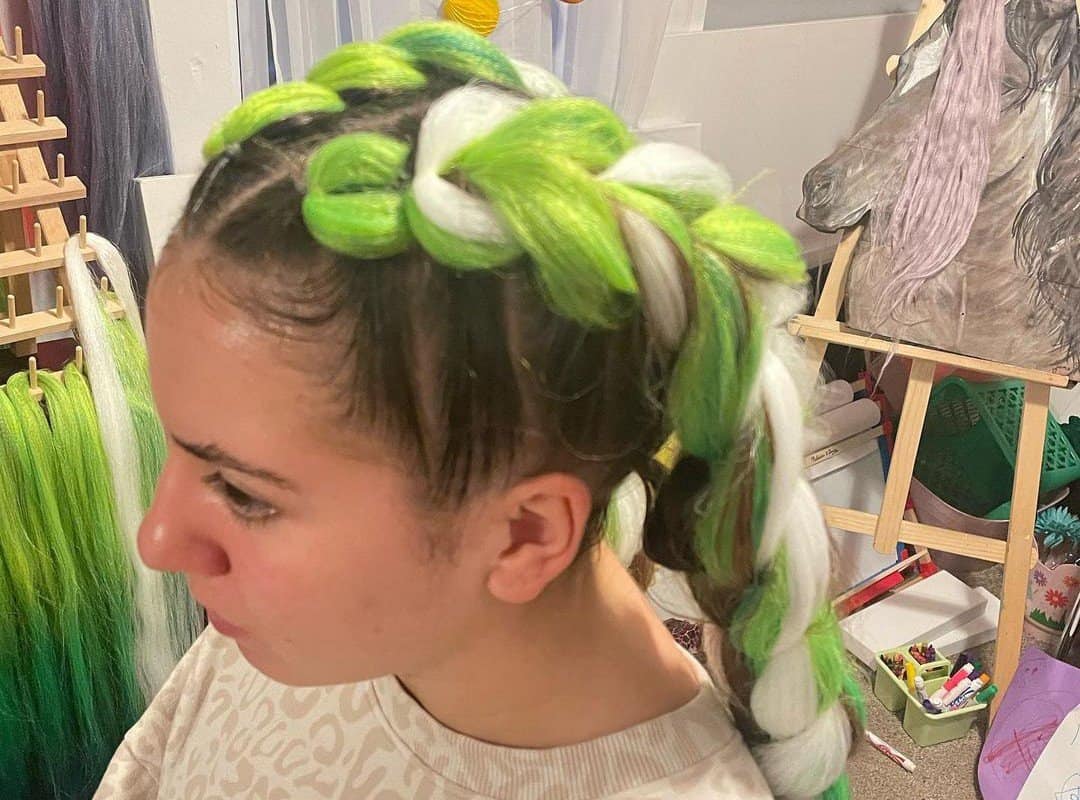 girl with green and white side braids