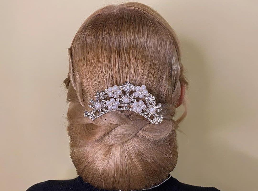 girl with light brown updo with a decoration
