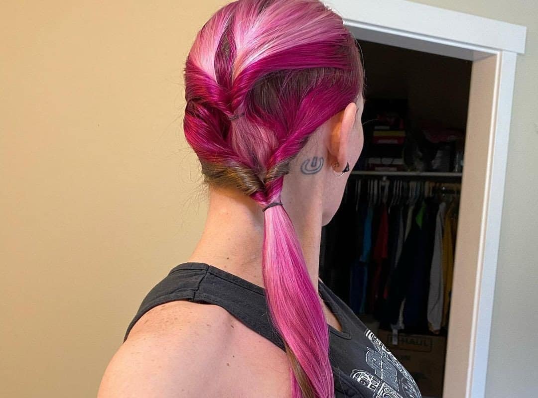 girl with red and pink high ponytail with a twist