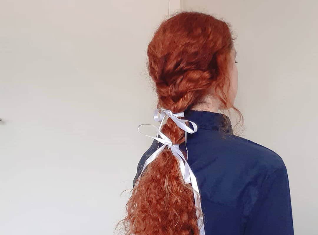 girl with red hair in a cottagecore hairstyle 