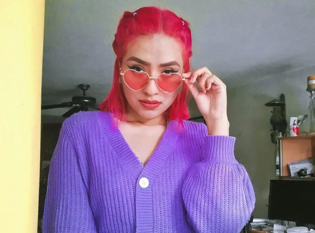 girl with red grunge aesthetic hairstyle and sunglasses