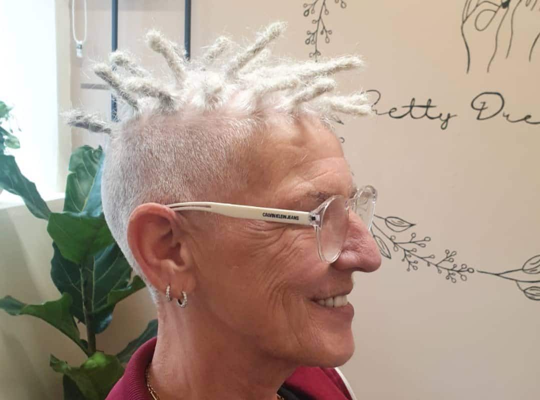 woman with silver short dyed dreads and glasses